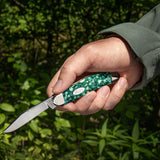 SparXX™ Smooth Green Kirinite® Sowbelly Open in hand outside
