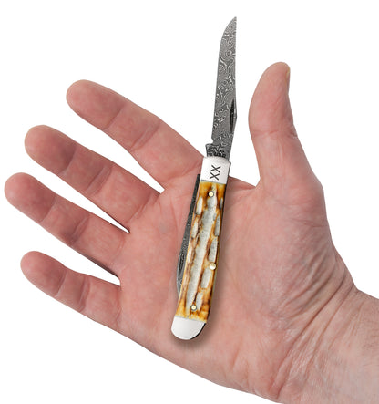 Deep Canyon Jigged Burnt Natural Bone Raindrop Damascus Mini Trapper In Hand