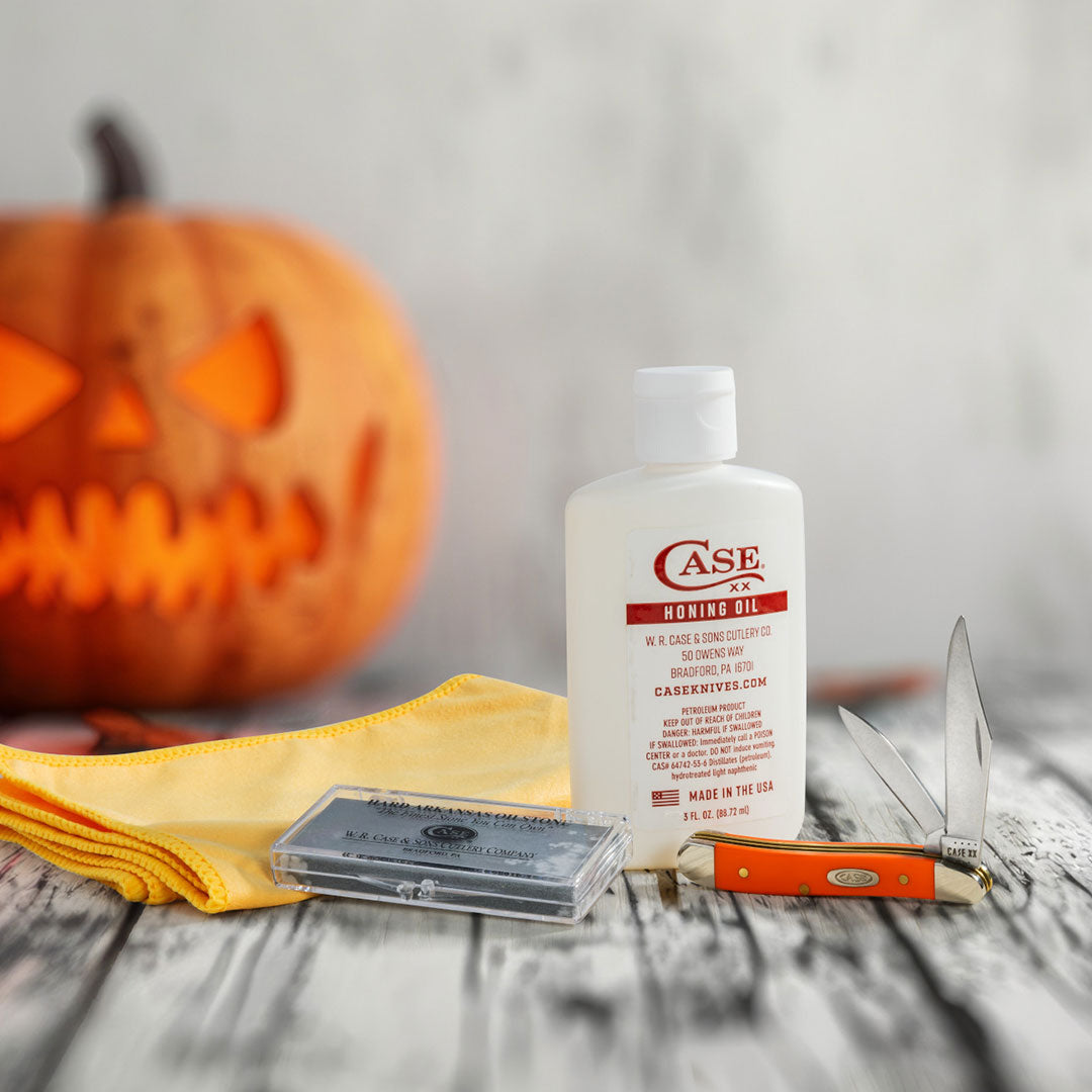 Case honing oil and polishing cloth on Halloween background.