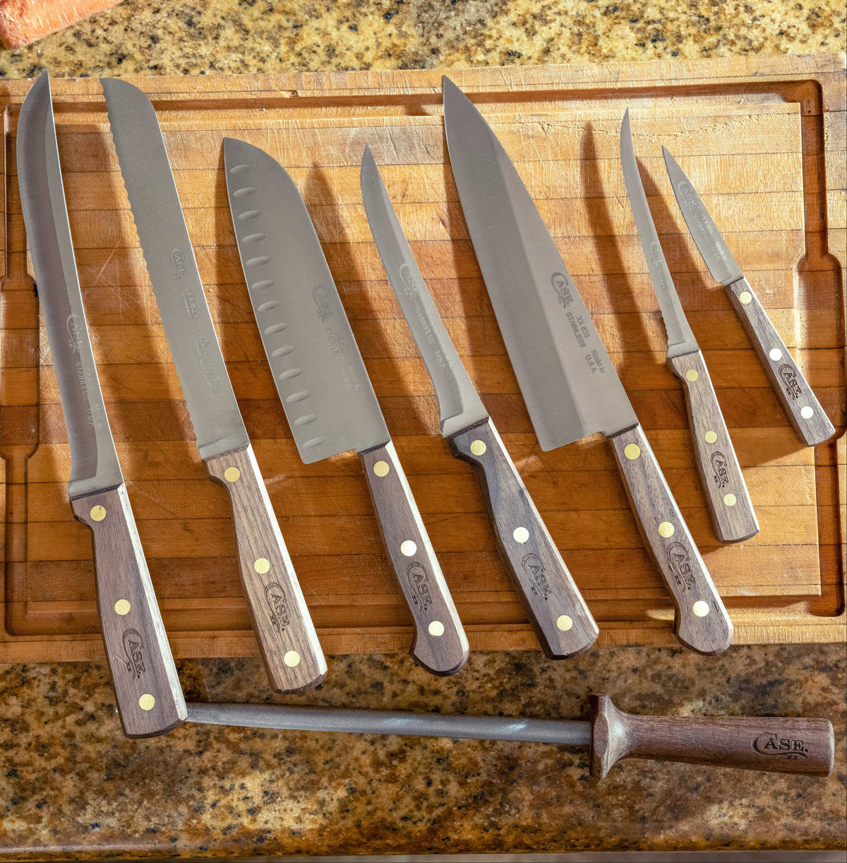 A set of seven Case kitchen knives with dark wood handles and silver steel blades, arranged on a wooden cutting board.