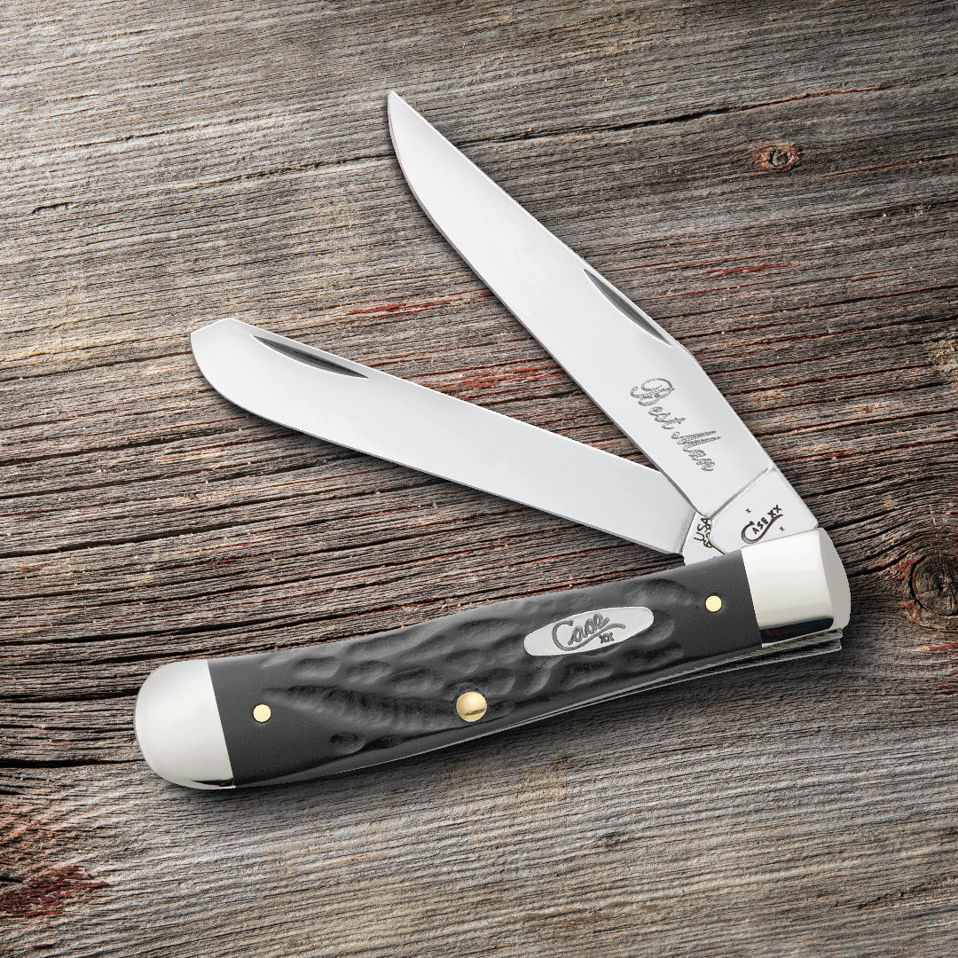 Custom engraved gray Case knife with two blades open on a wooden surface