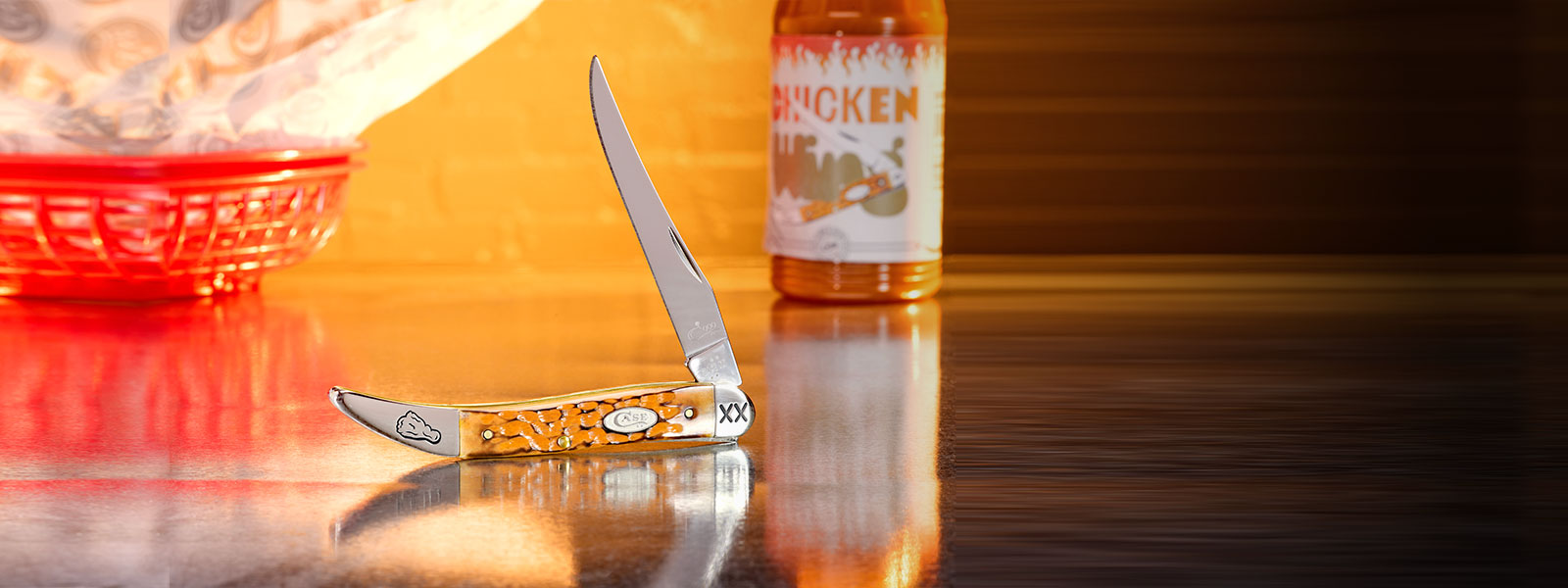 Case knife with a decorative handle on a table.