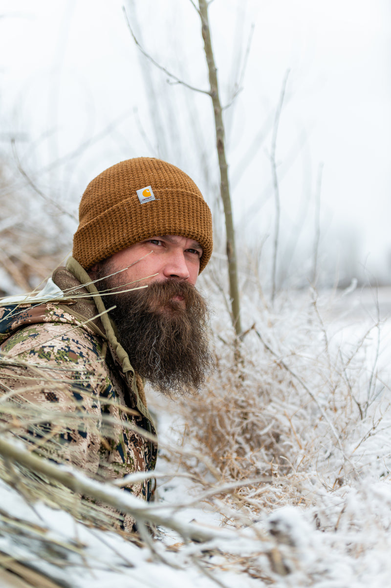 Gunnar Emberg in the woods with snow in the background.