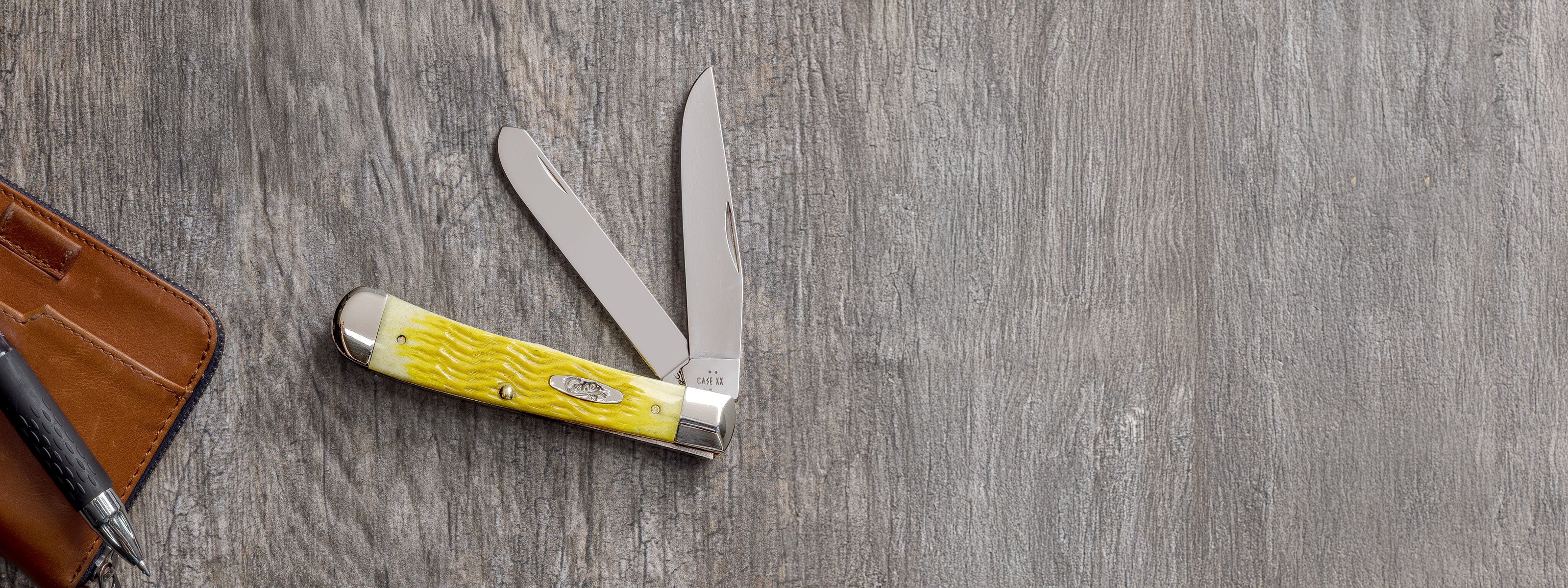 Platts Jig Yellow Bone Trapper on a gray wood background.