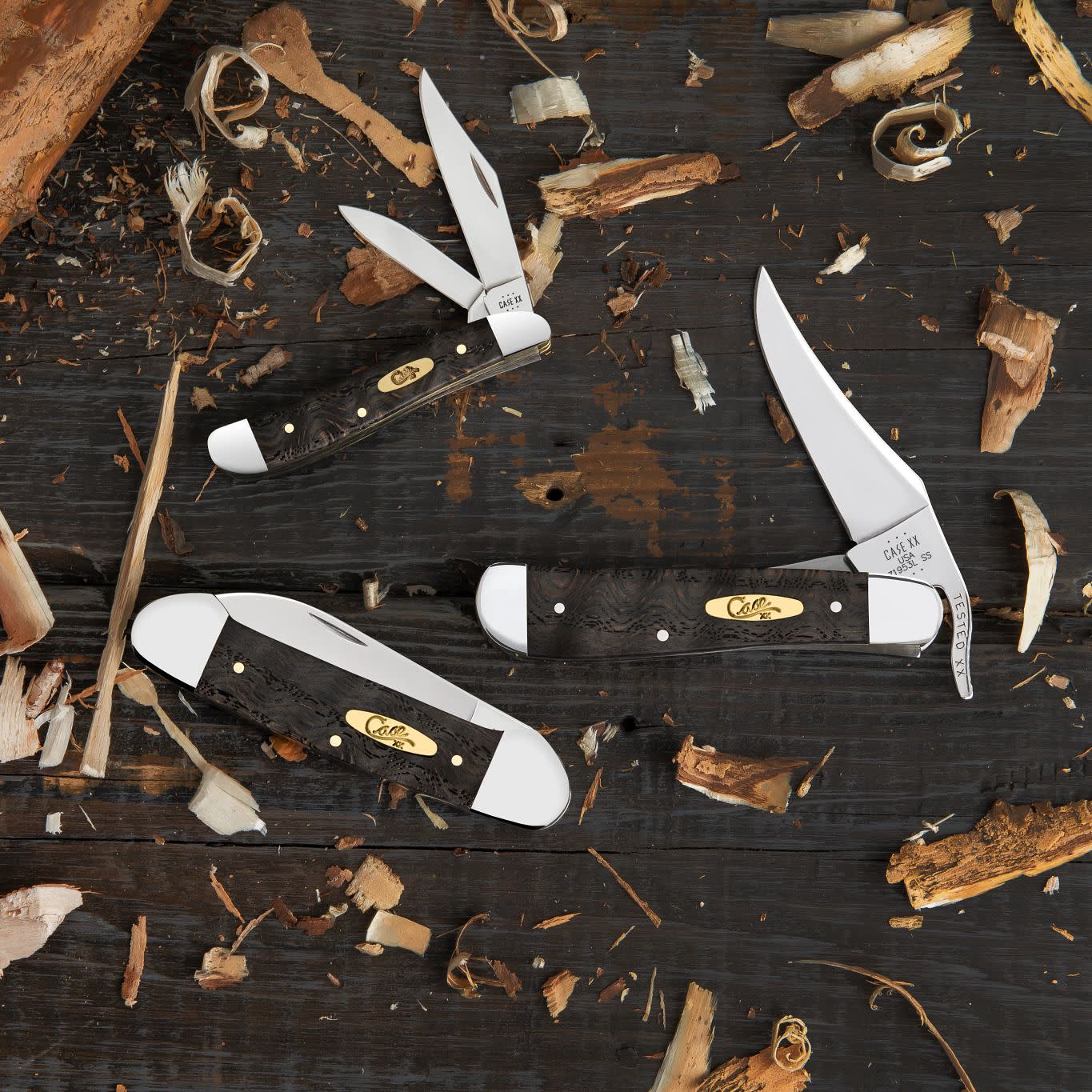 Smooth Black Curly Oak Wood Knives Front View on a Wooden background covered in leaves 