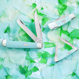 Smooth Seafoam Green G-10 Knives on a Floral Background 