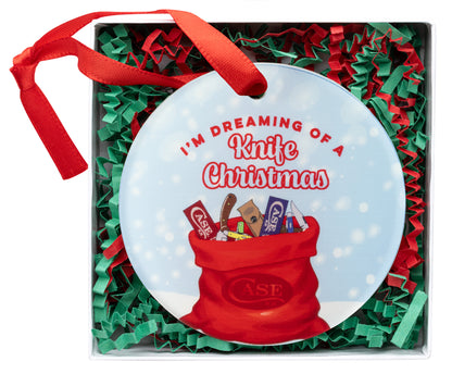 CCC® 2025 Christmas Ornament in white gift box with red and green stuffing confetti.