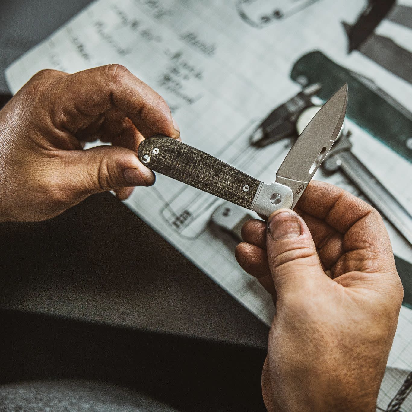 Smooth Black Burlap Micarta® Highbanks® in Hand