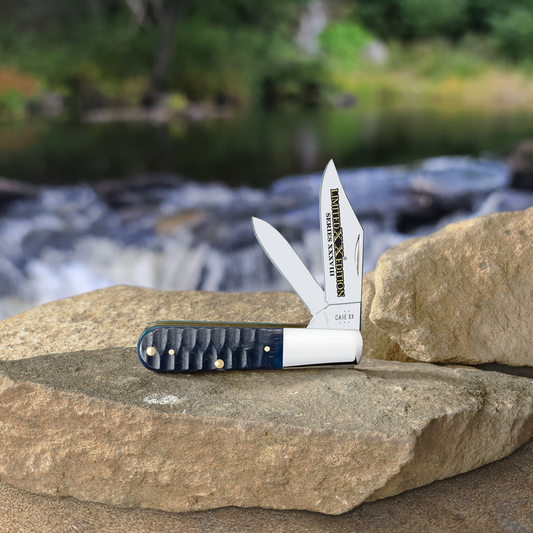 Limited XX Edition XXXVIII Gator Jig Ocean Blue Bone Barlow open and standing on a rock slab with a flowing stream blurred in the background.