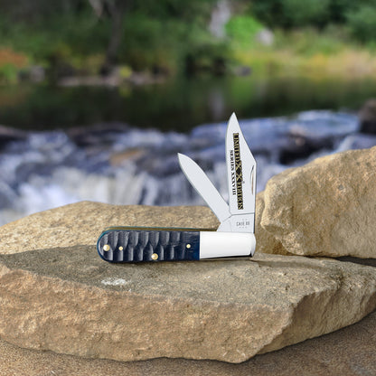 Limited XX Edition XXXVIII Gator Jig Ocean Blue Bone Barlow open and standing on a rock slab with a flowing stream blurred in the background.