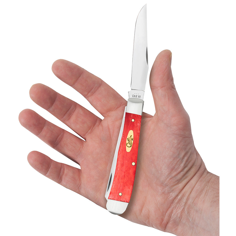 Smooth Dark Red Bone Trapper with Pinched Bolsters Knife in Hand
