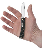 Jigged Rough Black® Synthetic Sod Buster Jr® Knife in Hand