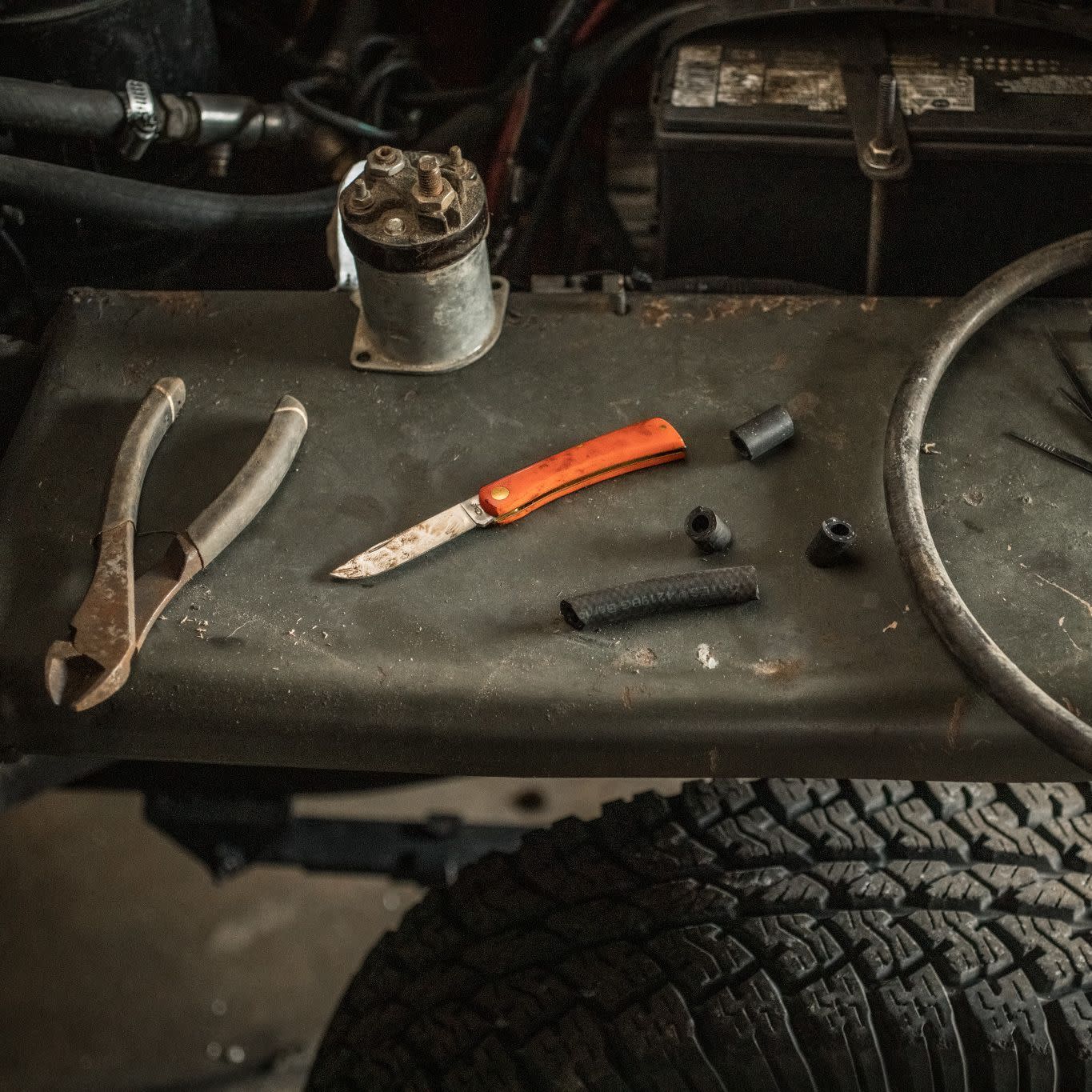 Orange Synthetic Sod Buster® Jr Knife on Work Bench