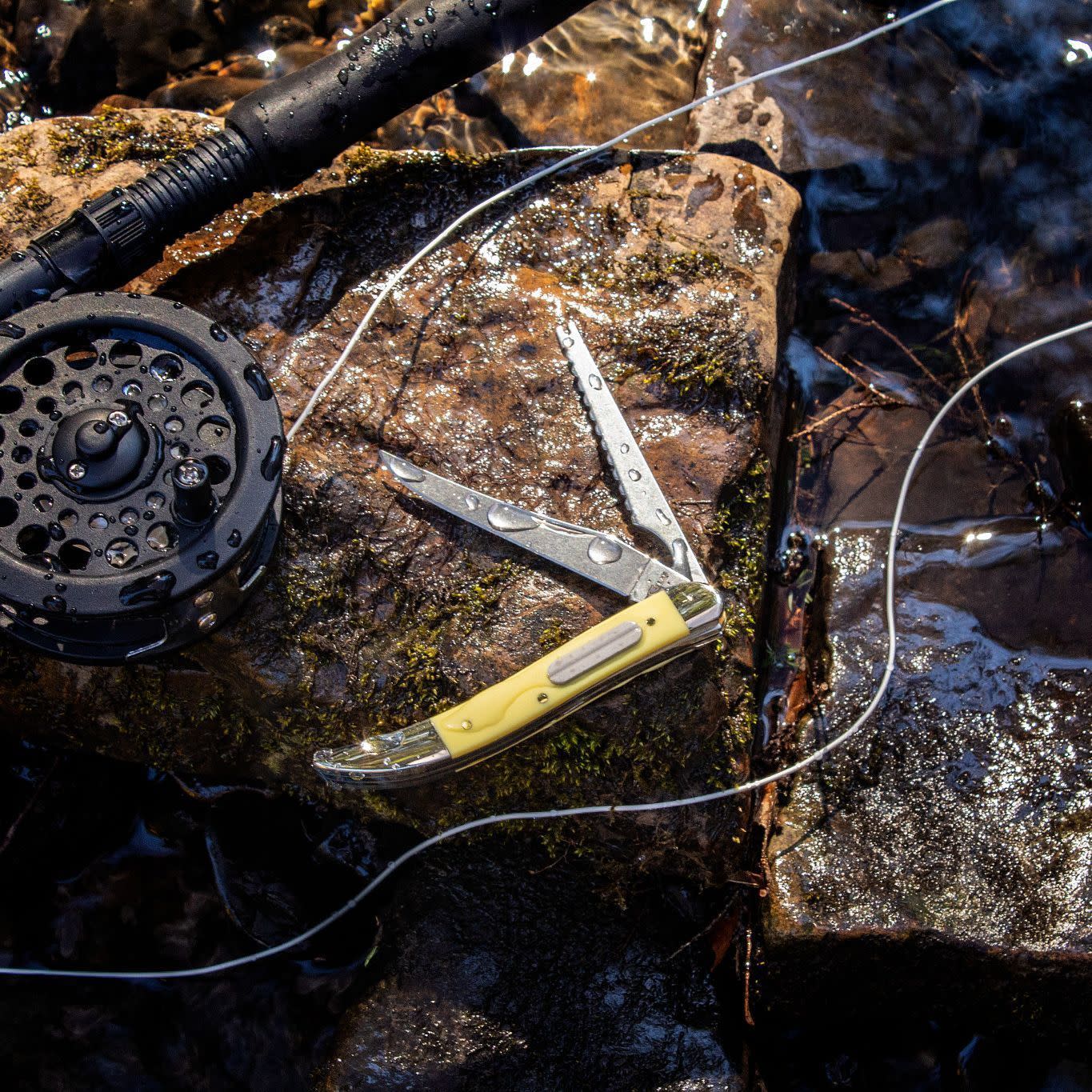 Yellow Synthetic Fishing Knife on Rock