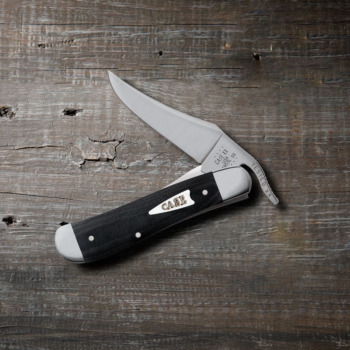 Smooth Black Micarta® Russlock® Knife on Wooden Background