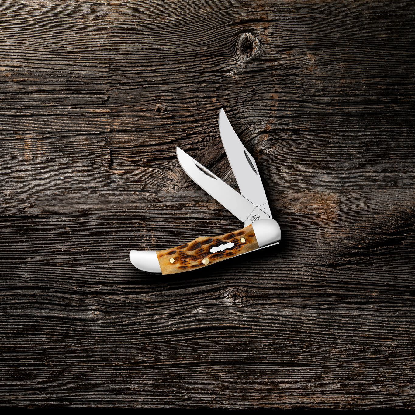 Pocket Worn® Peach Seed Jig Antique Bone Pocket Hunter Knife on wood background