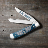 U.S. Navy® Embellished Smooth Mediterranean Blue Bone Trapper Knife on wooden background
