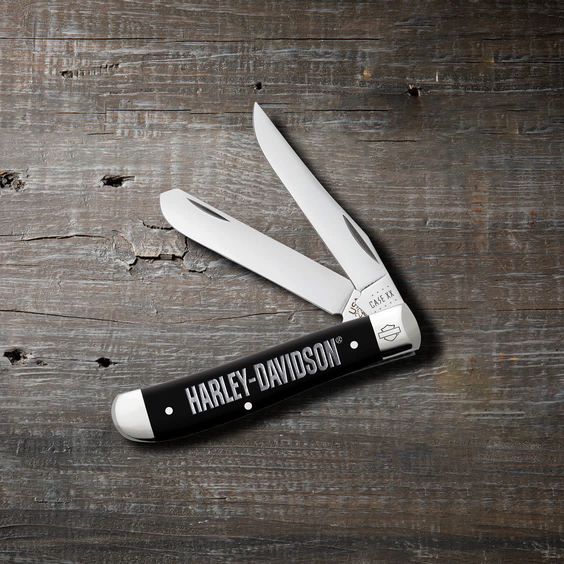 Harley-Davidson® Embellished Smooth Black Synthetic Mini Trapper Knife on Wooden Background