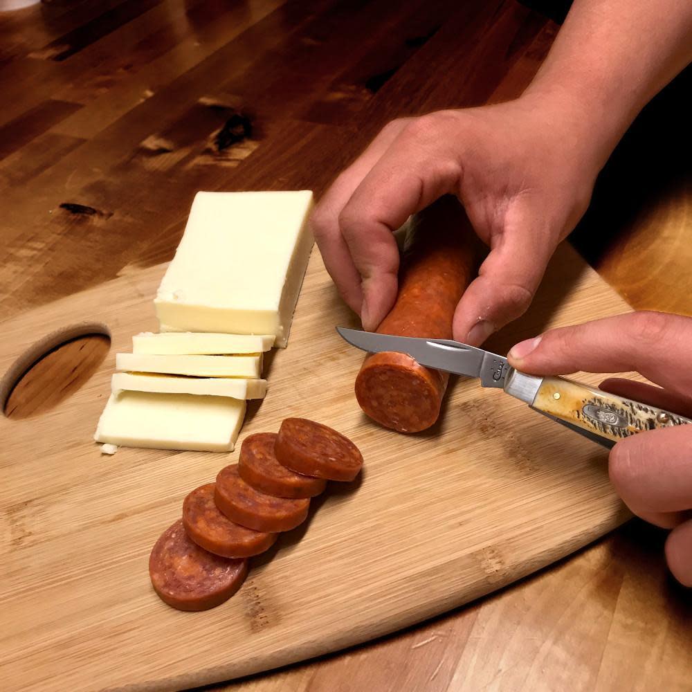 Case 6.5 BoneStag® Mini Trapper Knife Cutting Pepperoni and Cheese