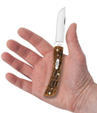 Peach Seed Jig Amber Bone CS Sod Buster Jr® Knife In Hand