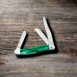 John Deere Smooth Green Pearl Kirinite® Medium Stockman Knife on Wooden Background