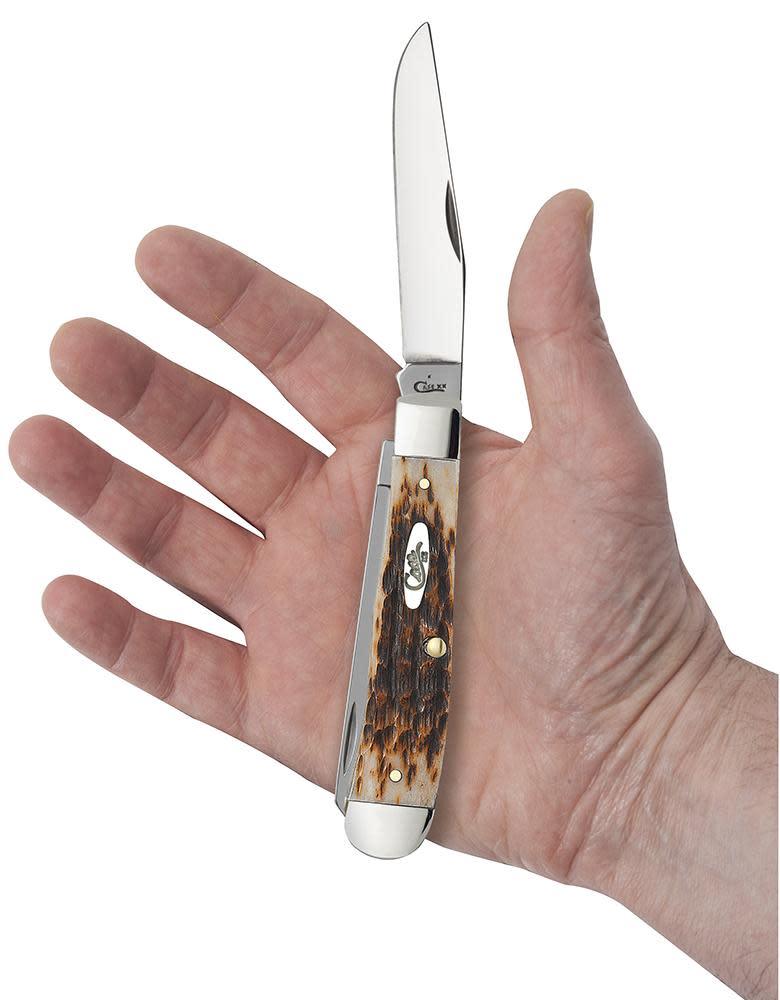Peach Seed Jig Amber Bone Trapper Knife in Hand