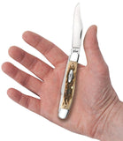 Peach Seed Jig Amber Bone Stockman Knife in Hand