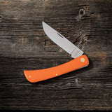 Orange Synthetic Sod Buster® Knife on Wood Background