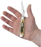 Peach Seed Jig Amber Bone Mini Trapper Knife in Hand