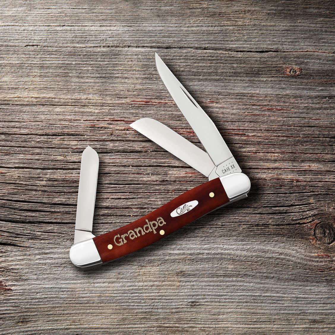 Embellished Smooth Chestnut Bone Medium Stockman Knife on Wood Background