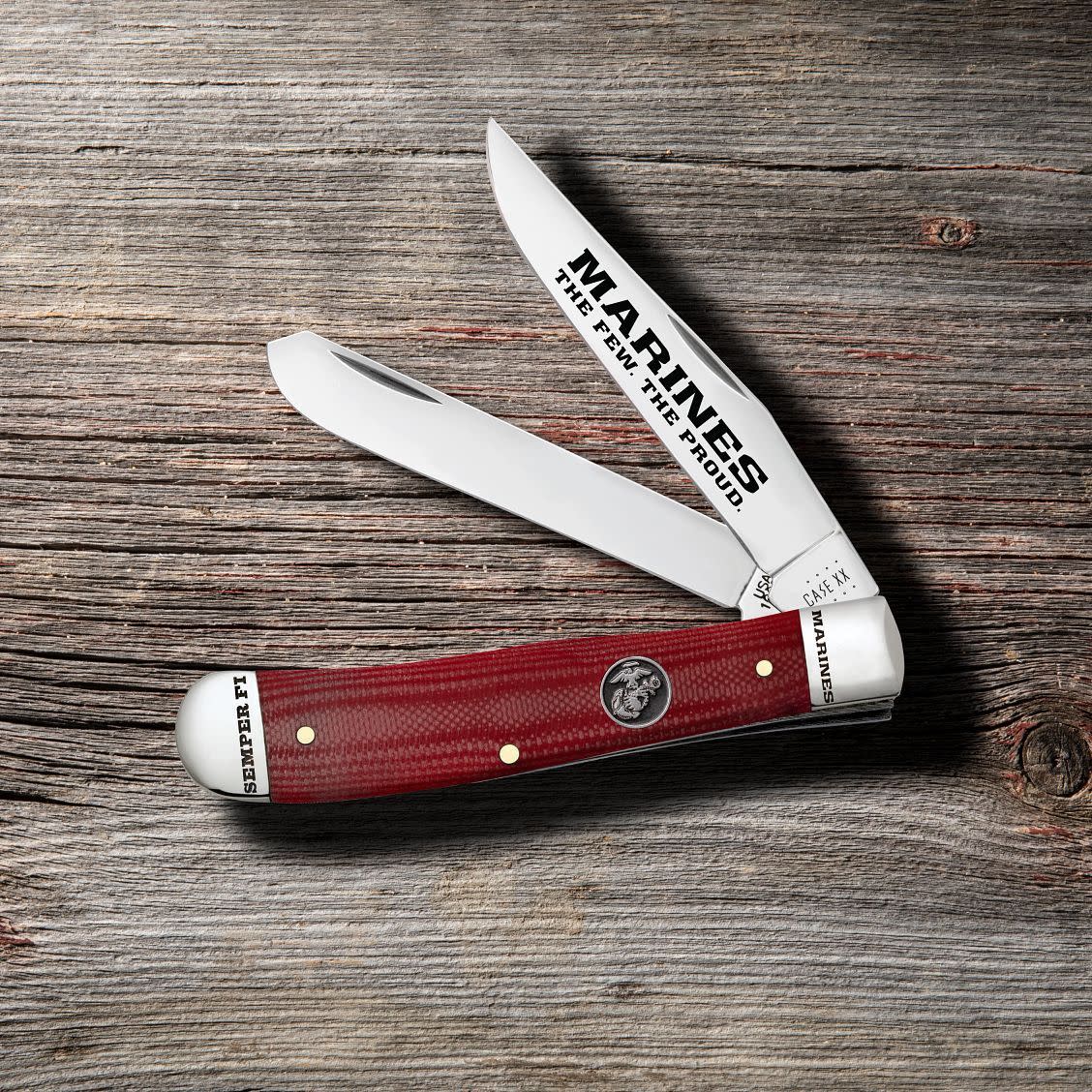 USMC® Smooth Red G-10 Trapper Knife on Wooden Background