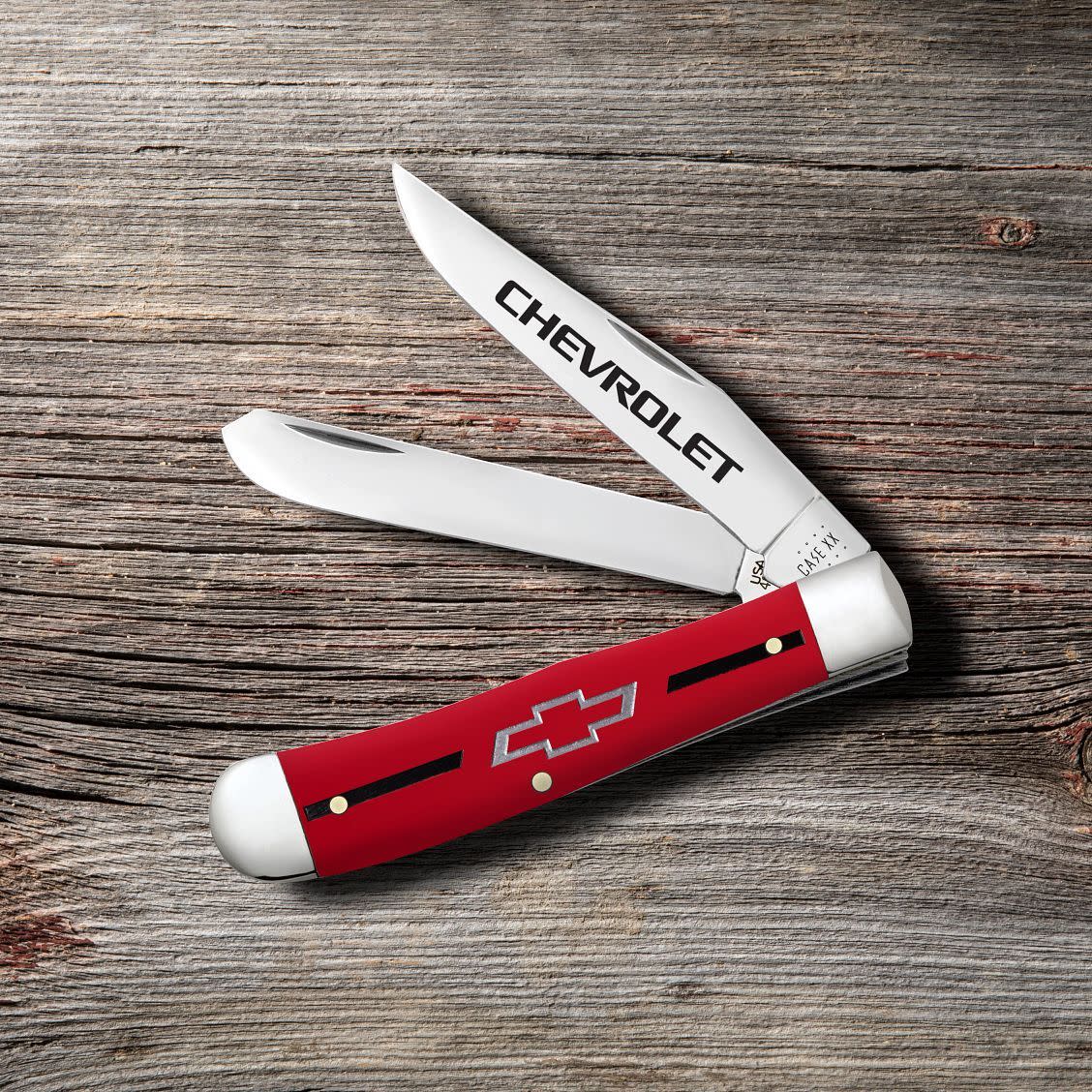 Chevrolet® Embellished Red Synthetic Smooth Trapper Knife on Wood Background