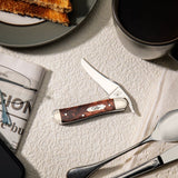 Smooth Brown Maple Burl Wood Russlock® Knife on a table top